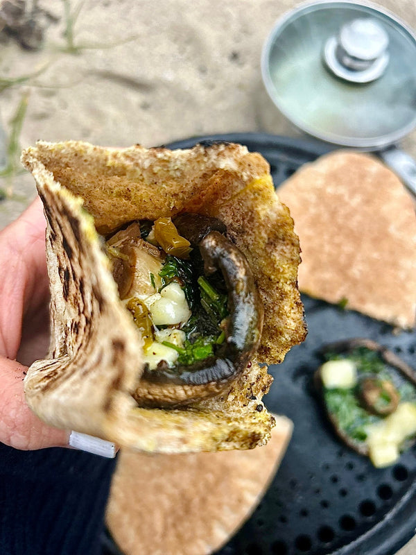 Mushroom burgers being cooked on the beach on a BBQ