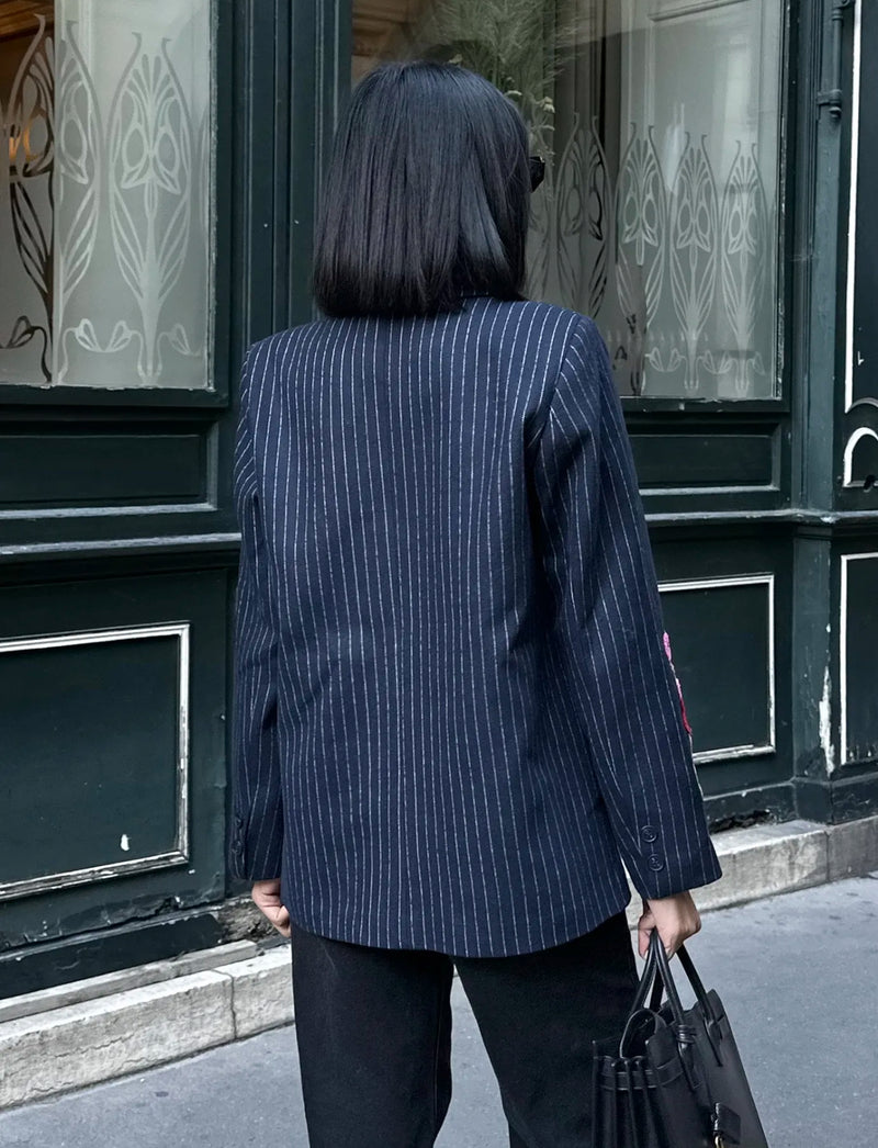 back of navy pinstripe blazer woman wearing