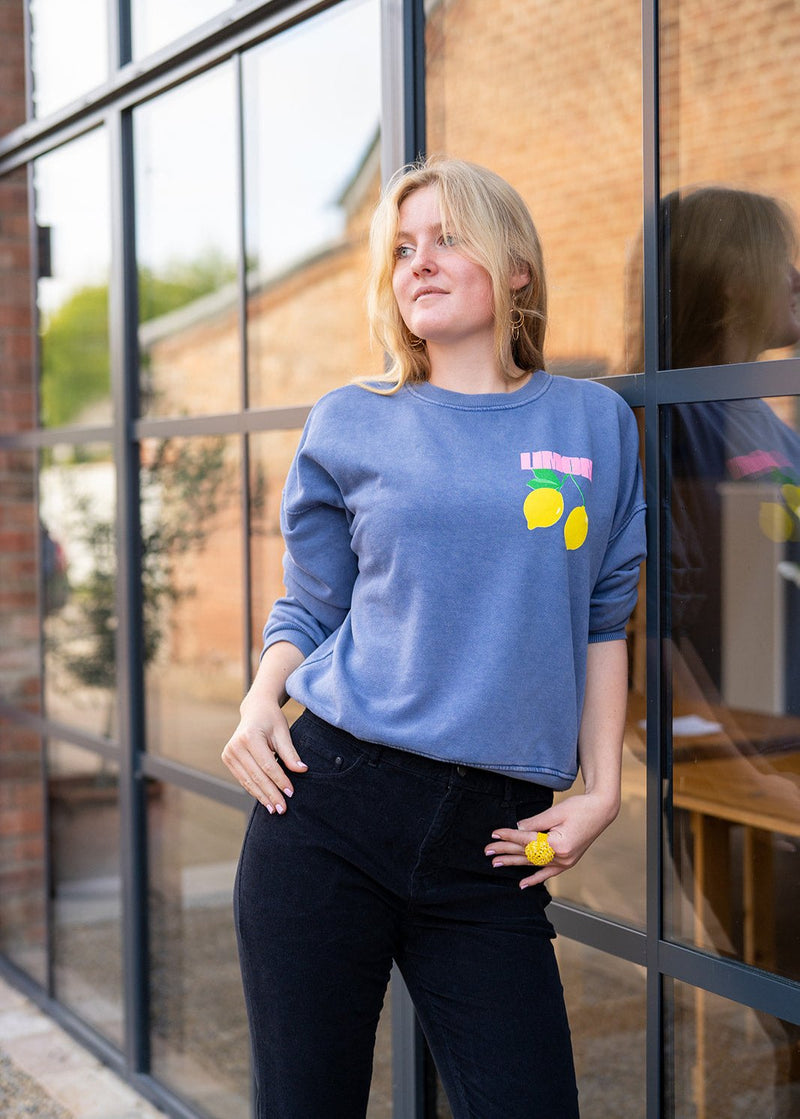 woman wearing Lemons sweatshirt (denim blue)