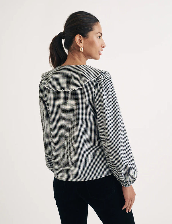 woman wearing Nobody's Child Birdie blouse (black gingham) from the back