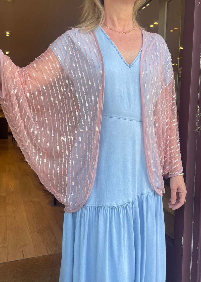 woman wearing Pink shimmery sheer kimono