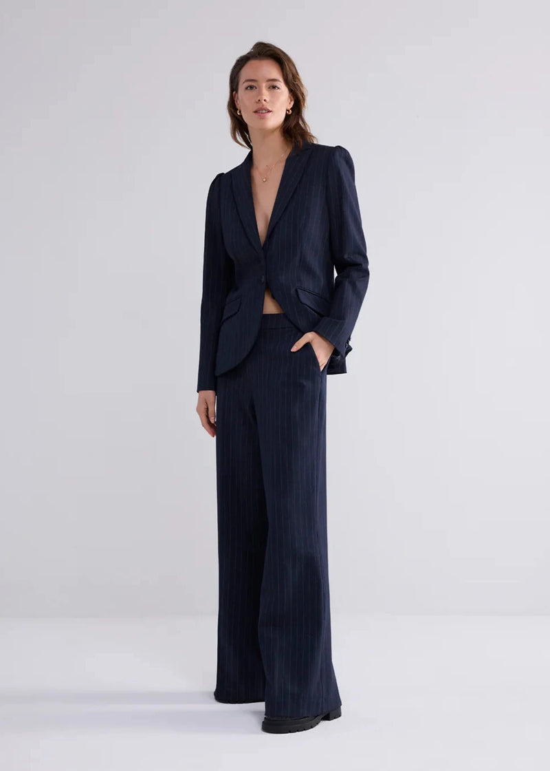 model wearing Summum Woman navy pinstripe trousers wideleg