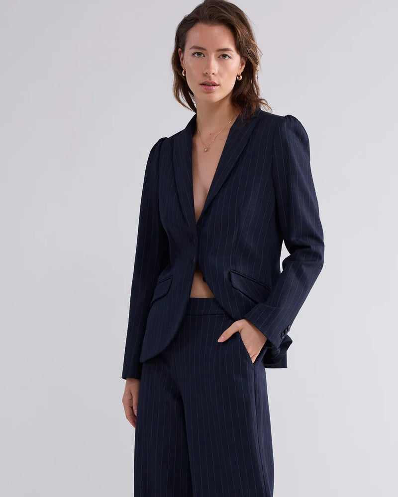 woman wearing Summum Woman navy pinstripe trousers close up