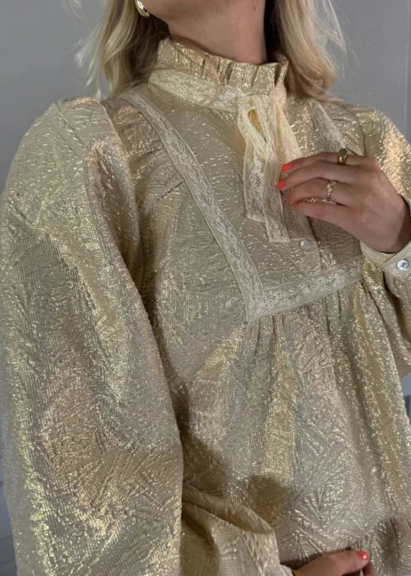 woman wearing Gold blouse