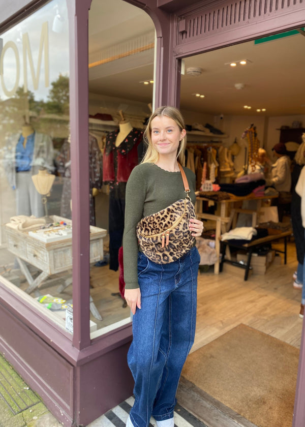 woman wearing a leopard print cross body bag