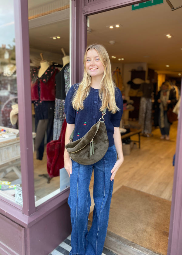 woman wearing Willa cross body bag (khaki) faux fur cross body bag