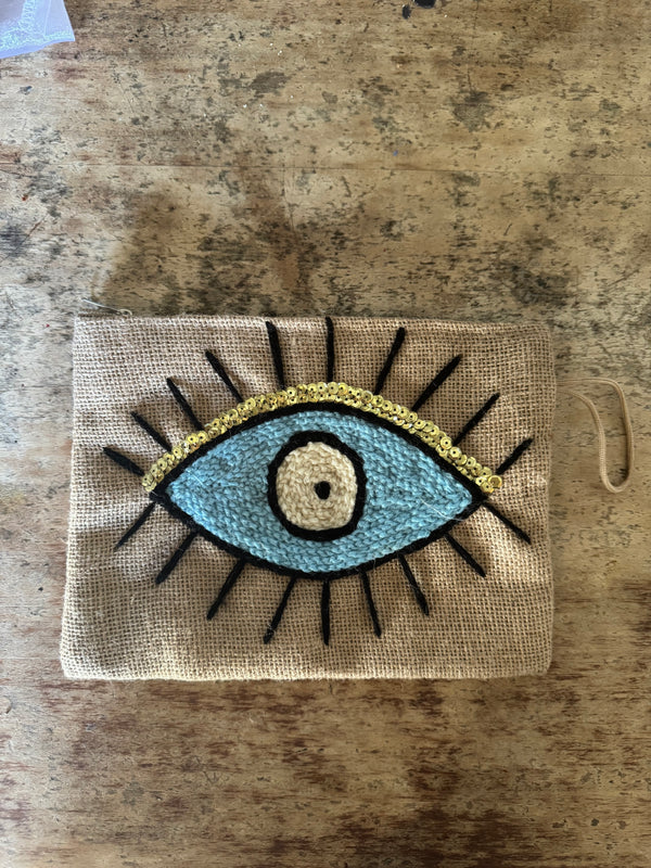 blue and yellow clutch bag with embroidered eye 