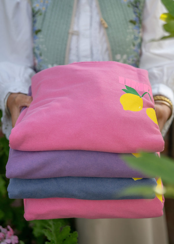 pile of pink and purple sweatshirts