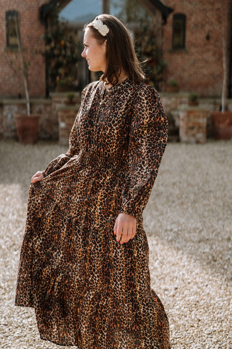 woman wearing leopard print maxi dress