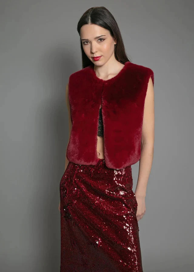 woman wearing a faux fur gilet from NOOKI in Edelweiss Gilet (Red) close up